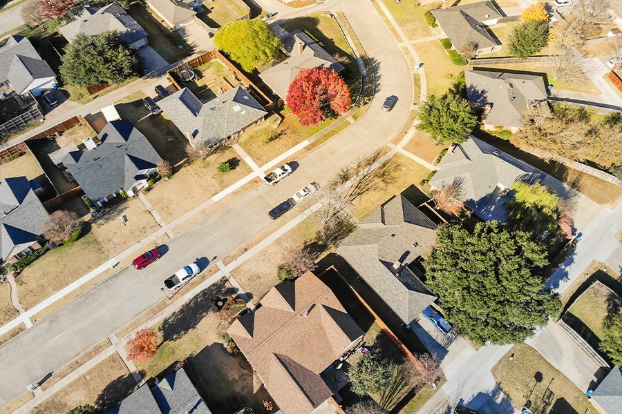 Contact - Straight Down View of New Development Neighborhood in Texas with Colorful Autumn Leaves